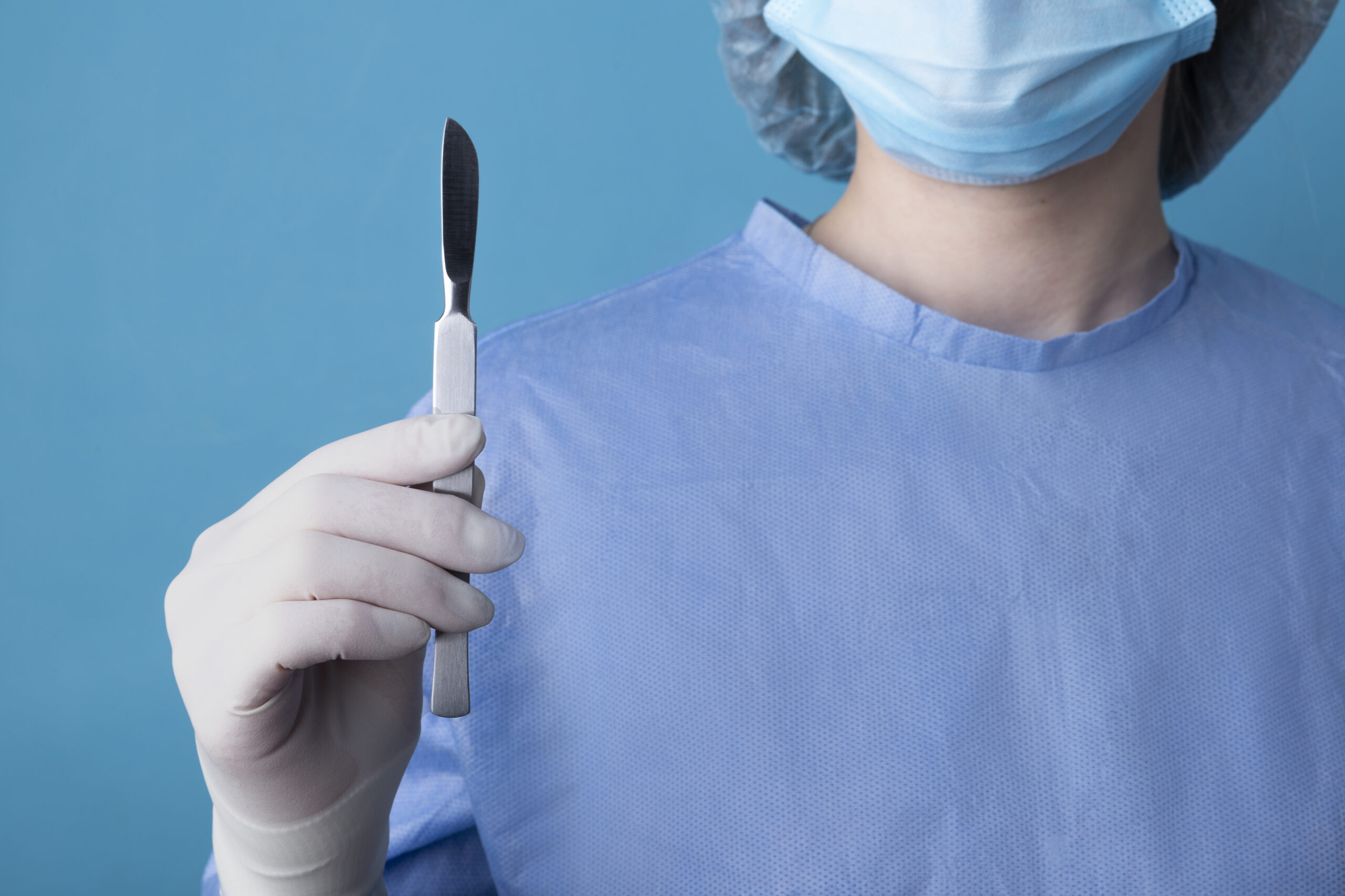 female-doctor-holding-metallic-medical-scalpel